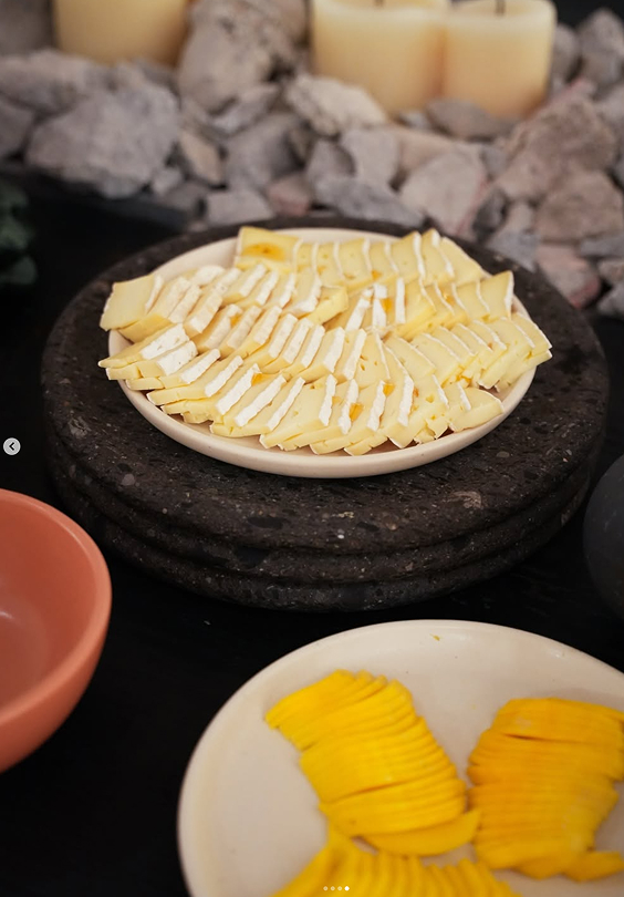 Cheese and food served on a table